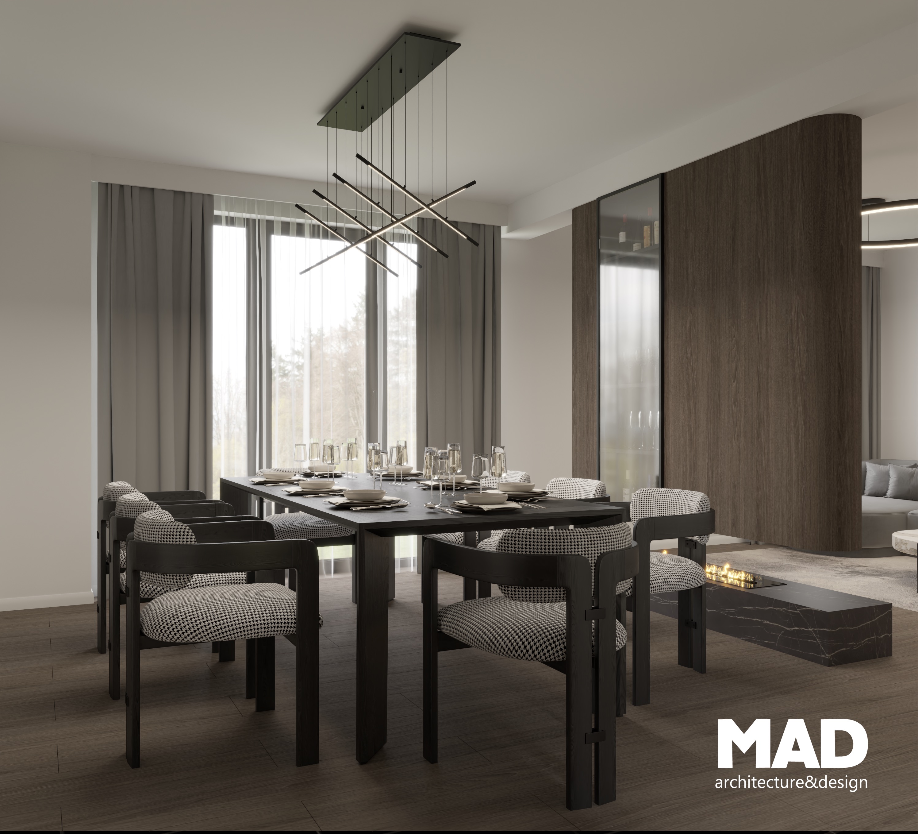 Zonă de dining elegantă, cu masă din lemn închis la culoare, scaune tapițate cu textură geometrică și corp de iluminat suspendat, amplasată lângă peretele despărțitor cu TV și șemineu bioetanol, design MAD architecture&design.