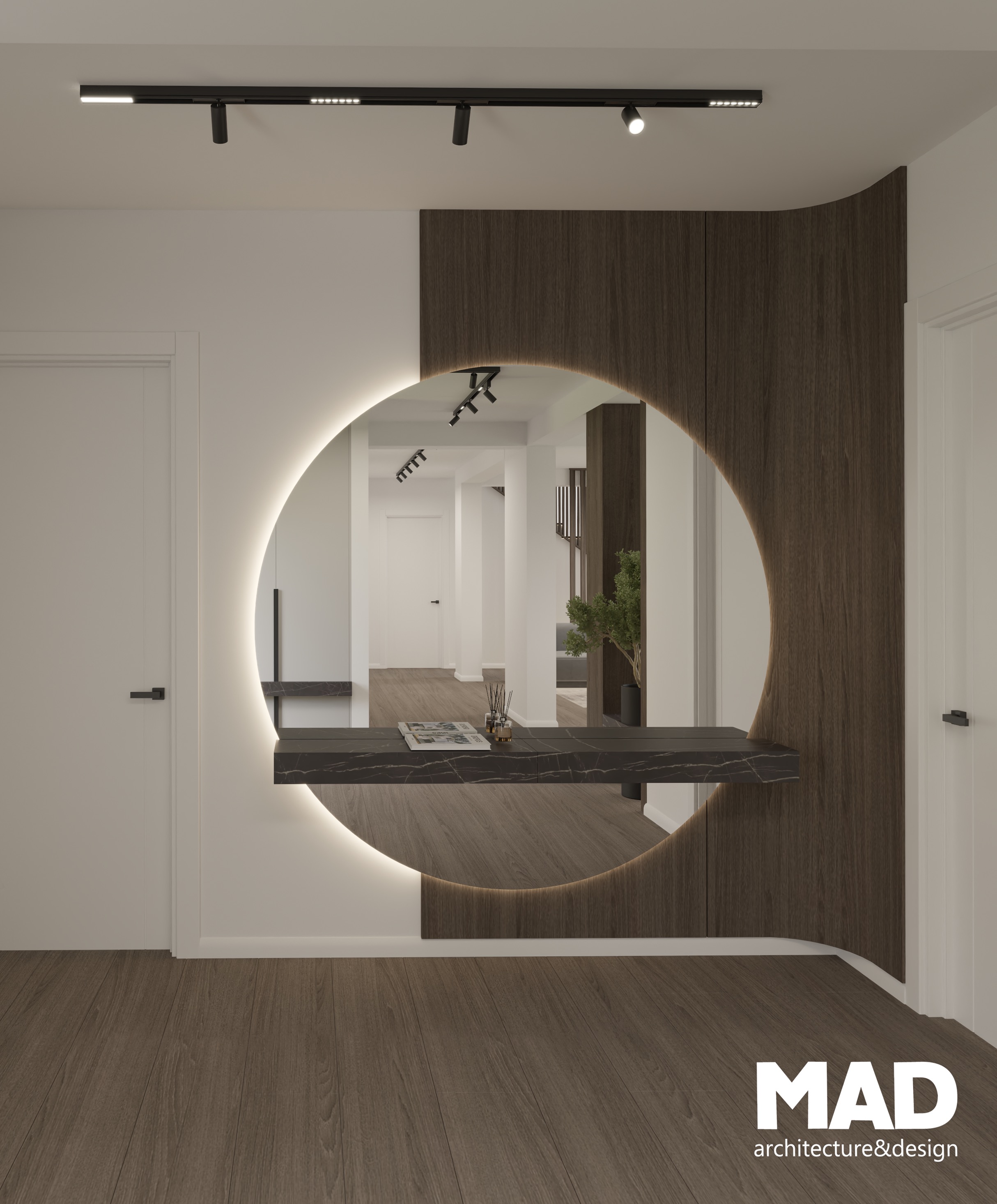 Zonă de intrare sofisticată, cu oglindă rotundă iluminată și consolă suspendată cu finisaj de marmură neagră, accente de lemn și design minimalist semnat MAD architecture&design.
