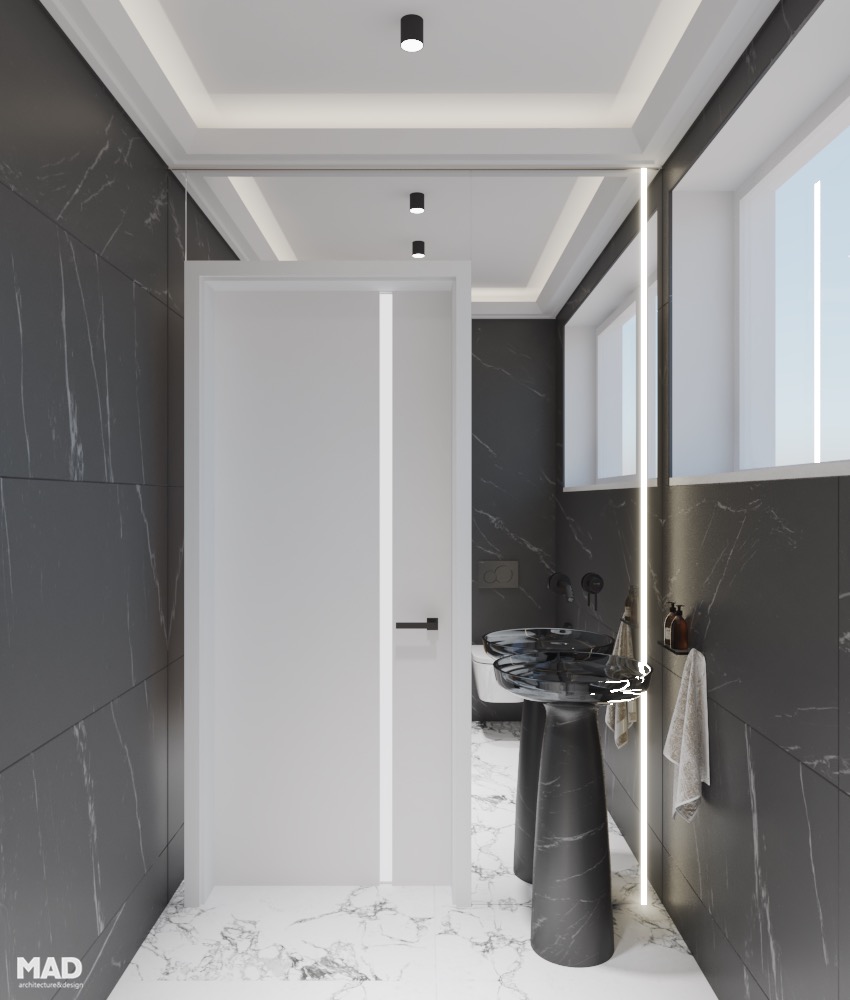 Baie luxury cu finisaje din marmură albă și neagră, lavoar sculptural freestanding și iluminare integrată, design MAD architecture&design.