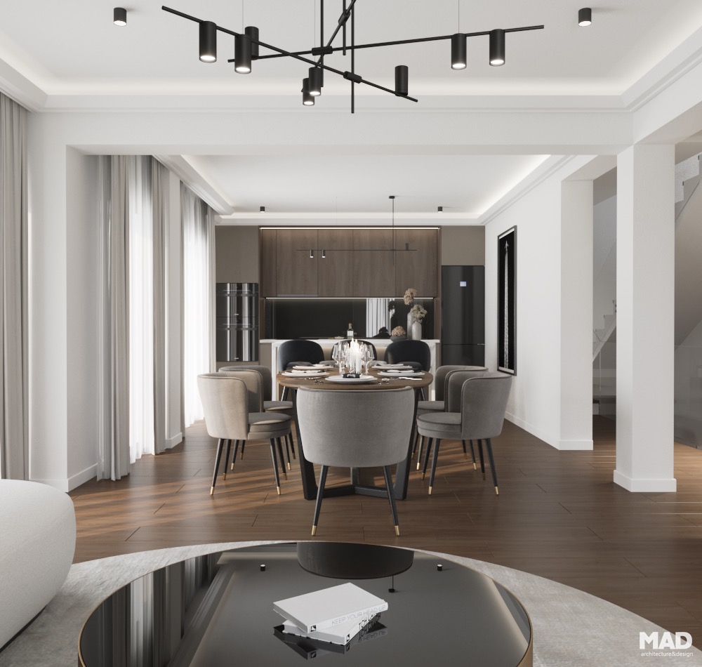 Spațiu open space de lux ce integrează living, dining și bucătărie, cu mobilier elegant, finisaje din lemn și accente aurii, semnat de MAD architecture&design.