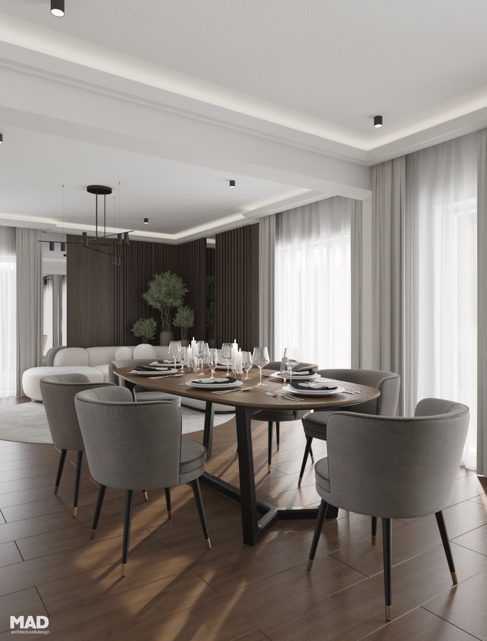 Zonă de dining elegantă cu masă ovală din lemn masiv, scaune tapițate în catifea gri și detalii metalice aurii, design MAD architecture&design.